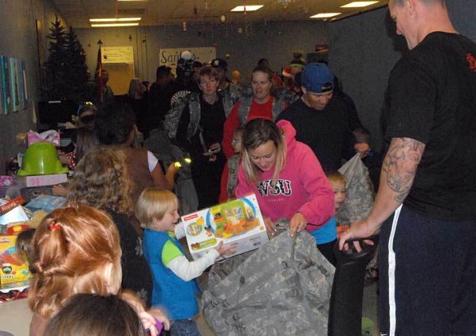 Child places holiday gift in camouflage bag 