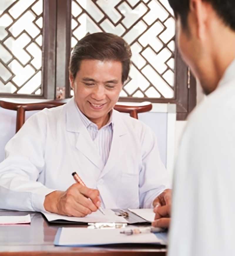 doctor makes notes with patient