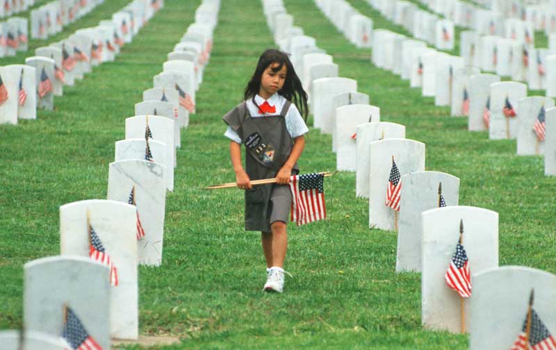 girl walks through cemetary