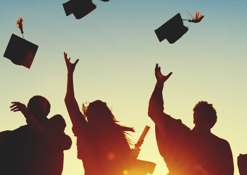 people throw graduation caps